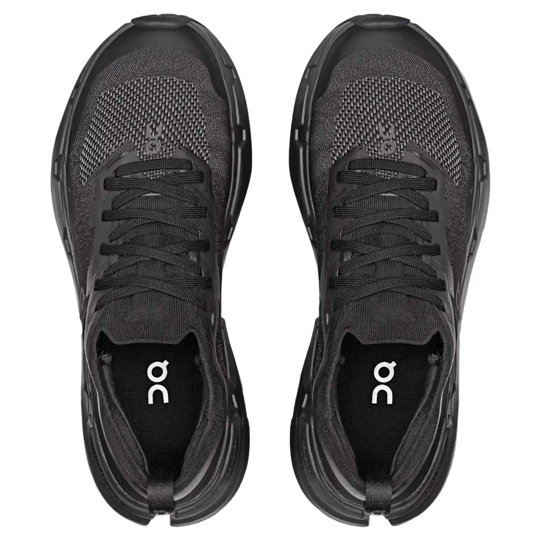 Black running shoes with 'on' logo on a light gray background