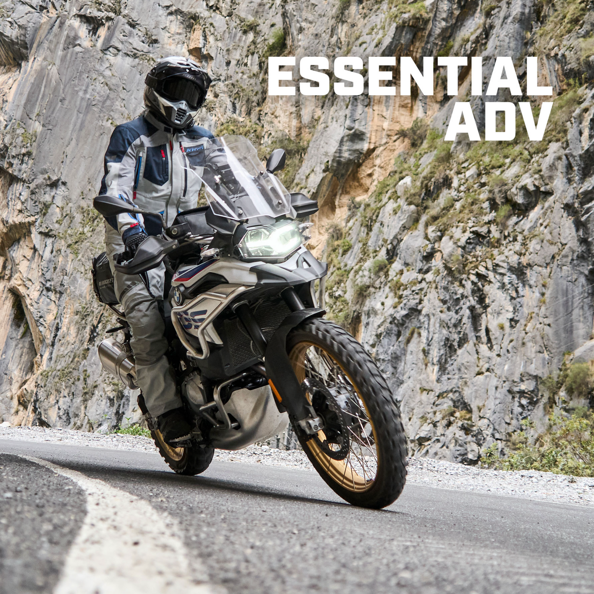 Motorcyclist on a mountain road with 'Essential ADV' text