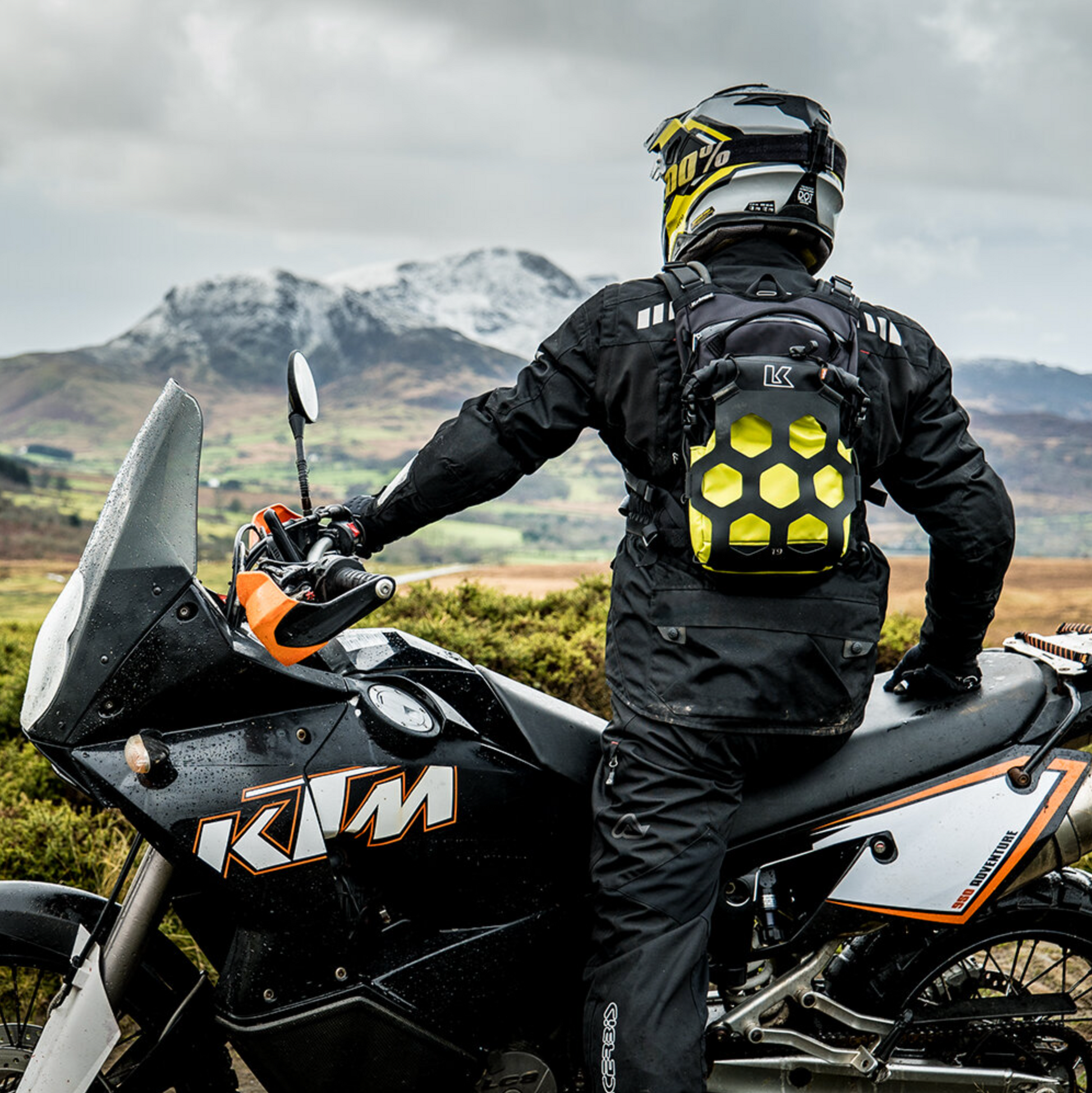 Person on a KTM motorcycle with a scenic mountain backdrop