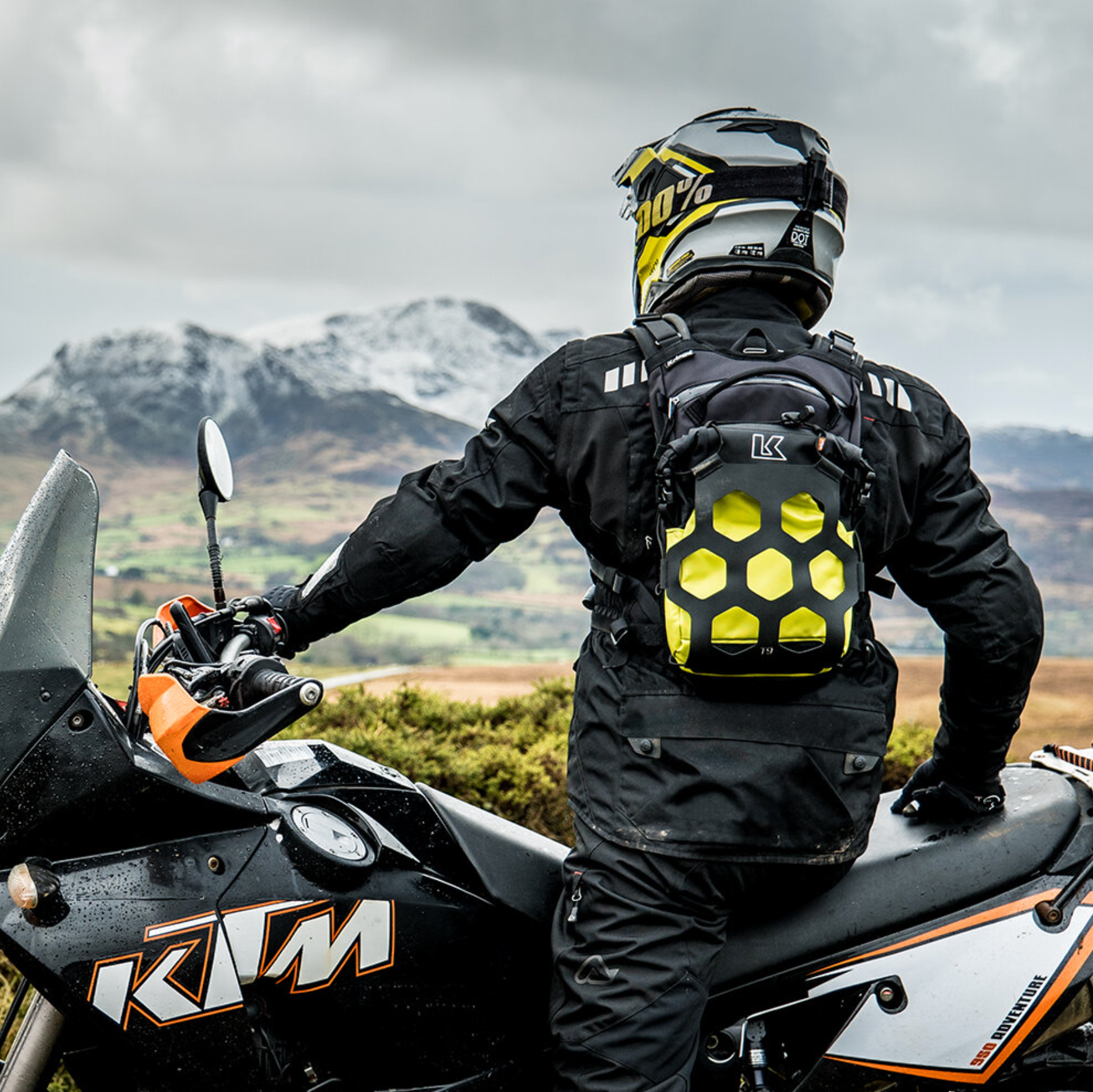 Person on a KTM motorcycle with a scenic mountain backdrop