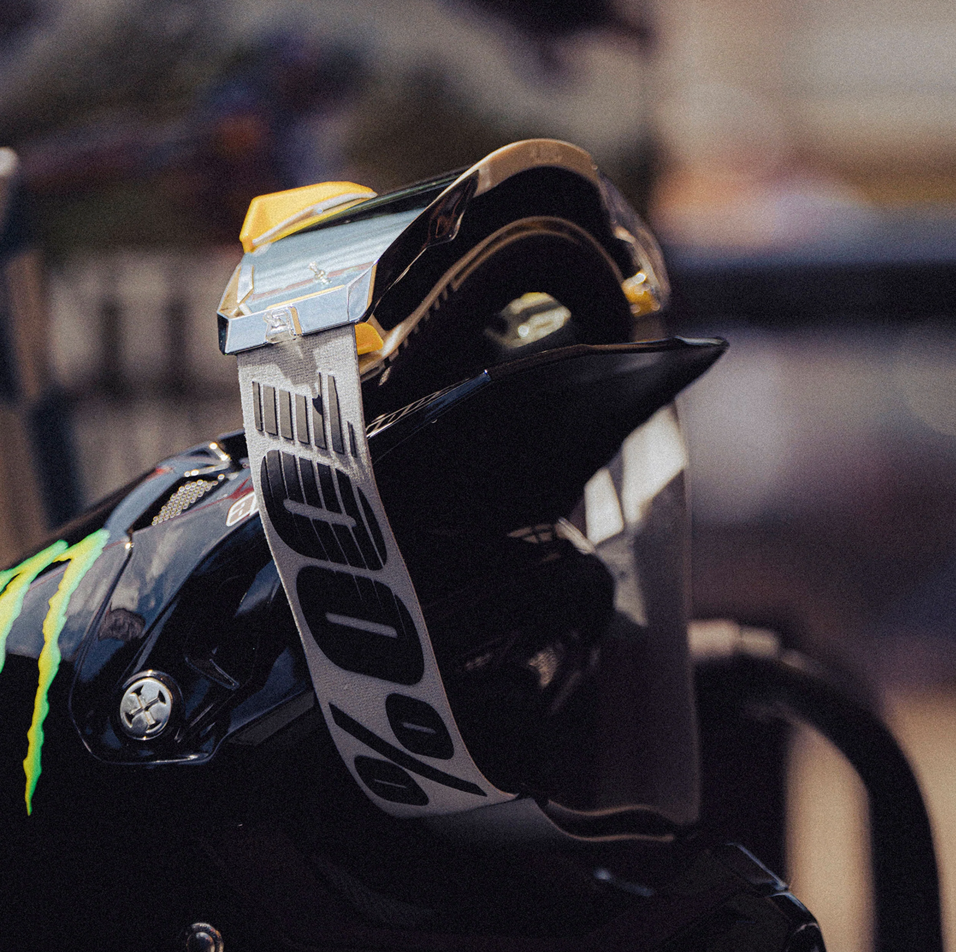 Close-up of a black glove with a brand logo on a blurred background