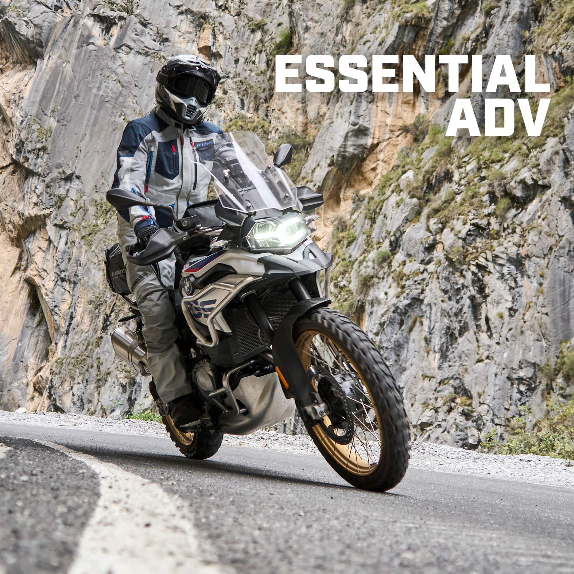 Motorcyclist on a mountain road with 'Essential ADV' text