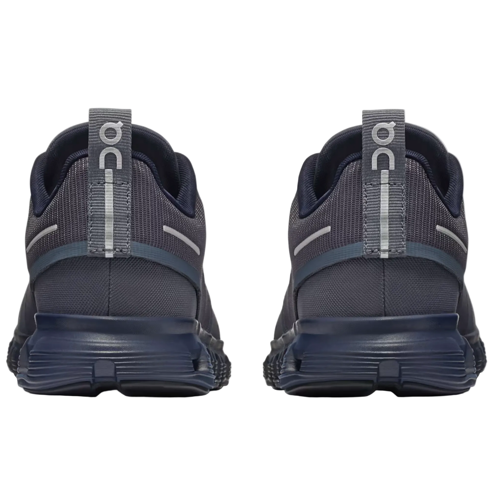 A pair of dark gray and navy blue running shoes shown from the back, featuring a textured mesh upper, a thick navy sole, and a gray pull tab with the 'on' logo.