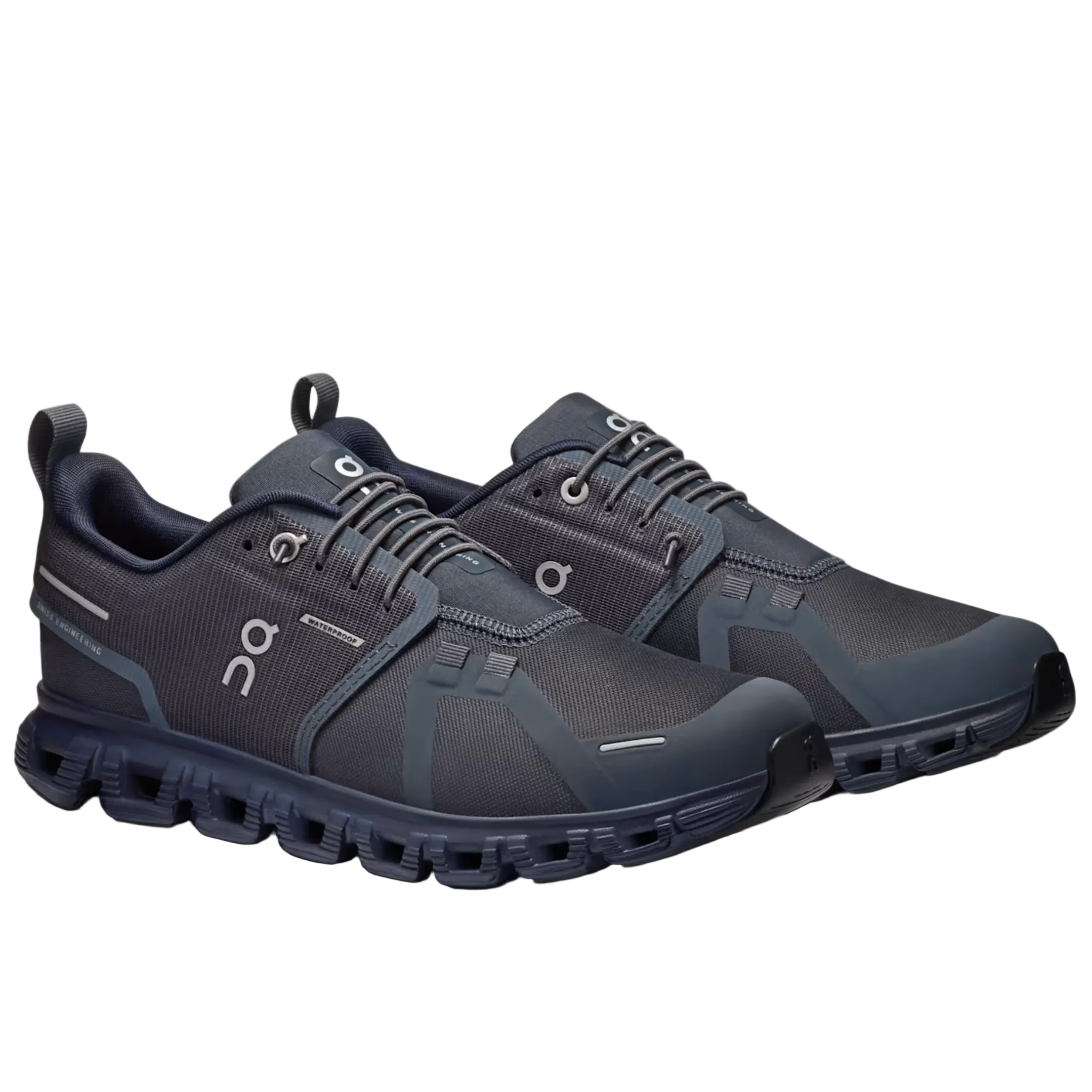 A pair of On running shoes in dark gray and navy blue, displayed on a light gray background.
