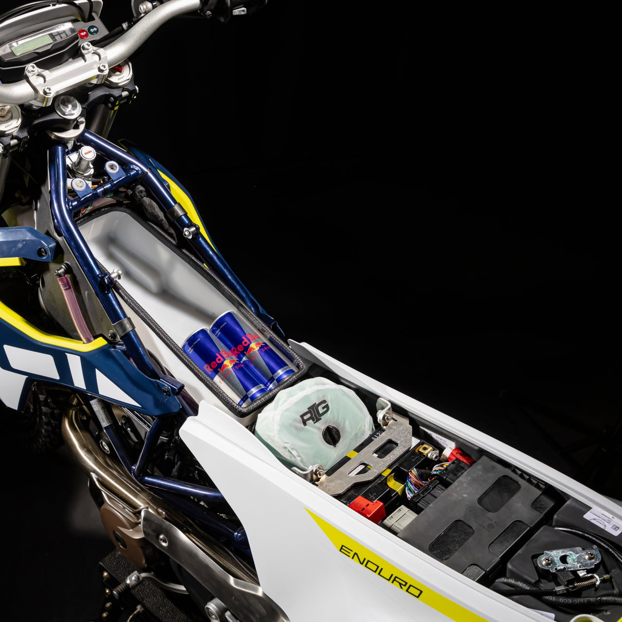 Close-up of a motorcycle's suspension system with visible branding on a dark background